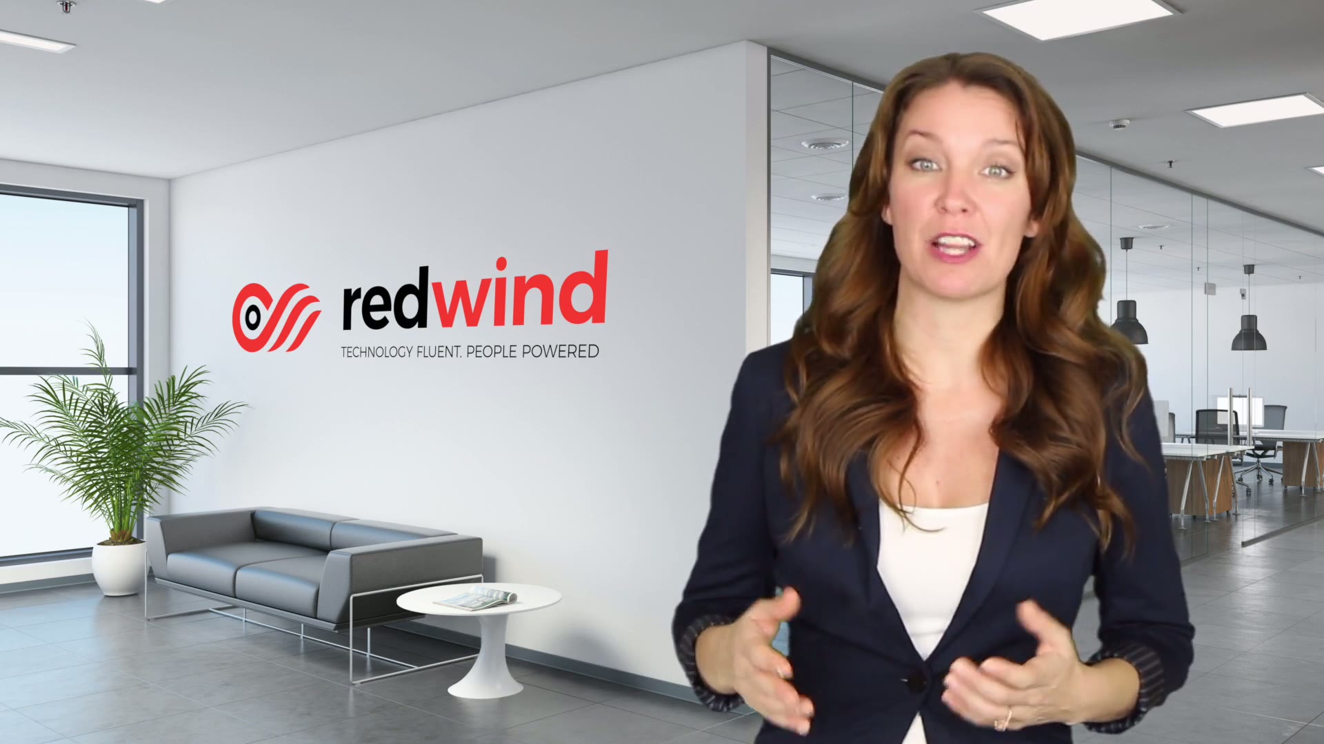 A Redwind presenter in front of the Redwind brand wall